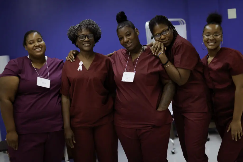 Group of women smiling at CNA training