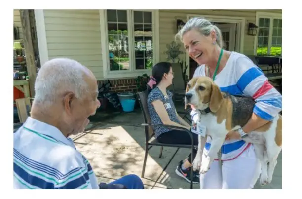 Ariel the dog with resident and woman