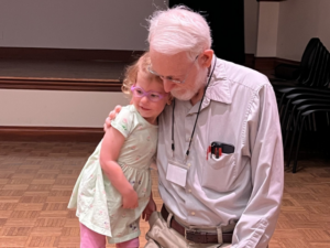 older man and child in embrace