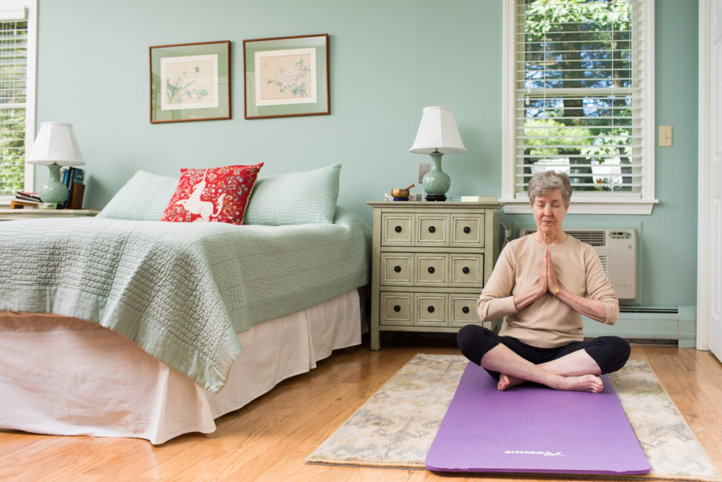 Woman practices mindfulness in her bedroom