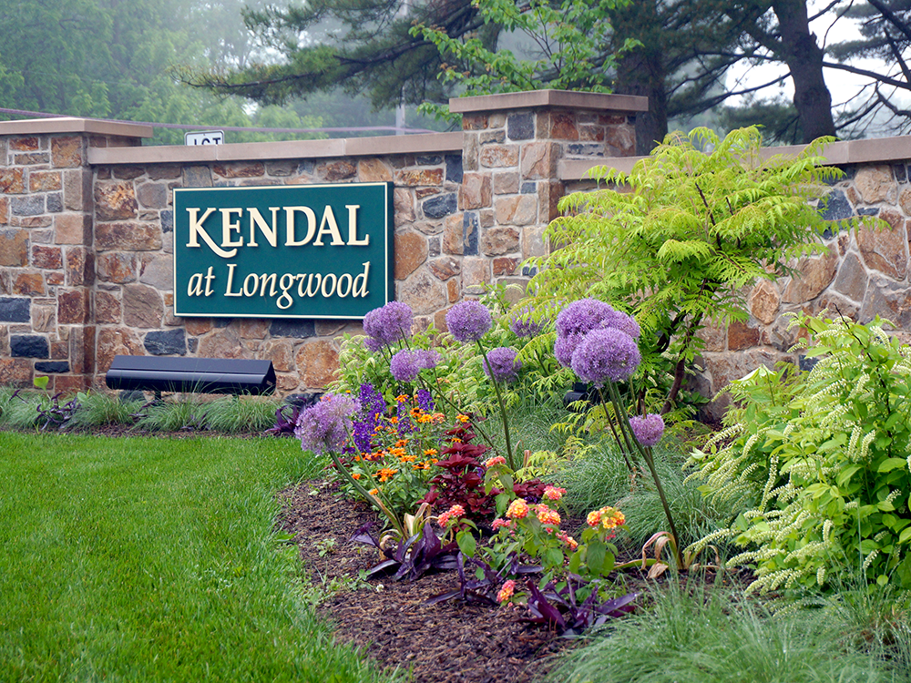 Kendal at Longwood landscaped entry sign in spring