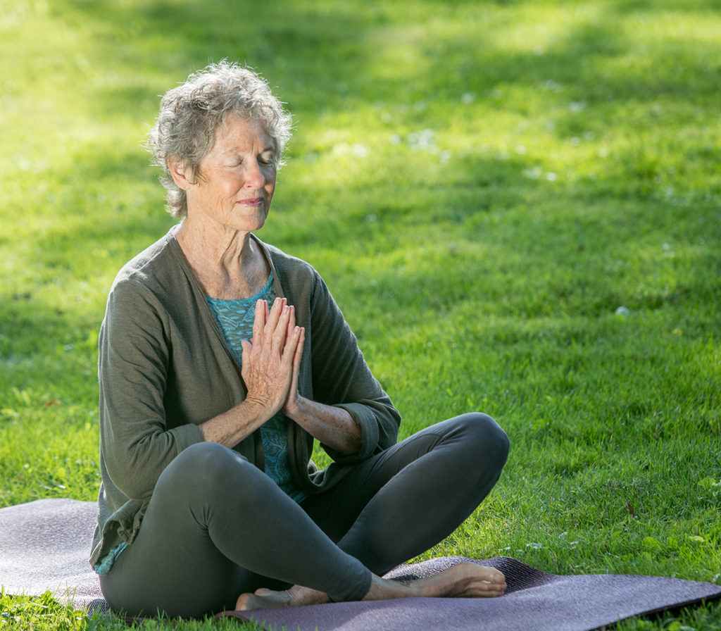 Woman meditates outdoors