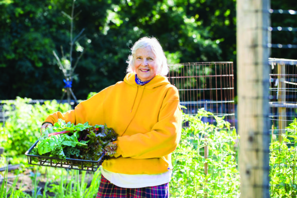 Senior living resident works in community garden