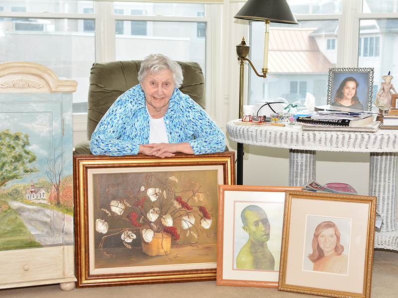 Resident artist with her paintings