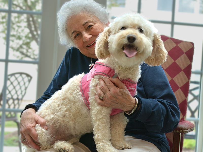 Resident with dog on her lap
