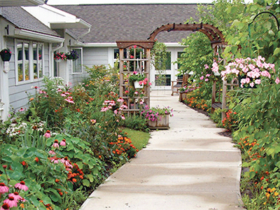 Flowers blooming along walkway between cottages