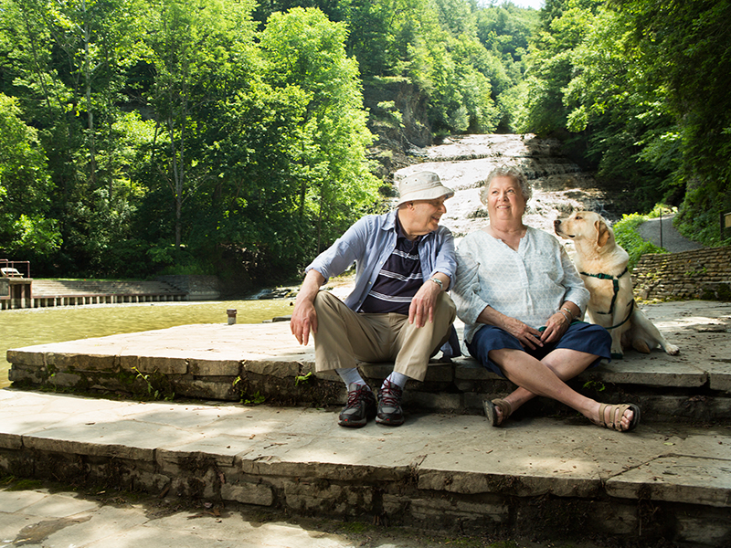 Resident couple with dog alongside a gorge