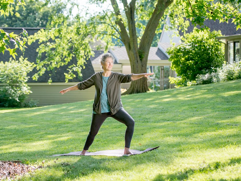 KCC resident in yoga pose outdoors