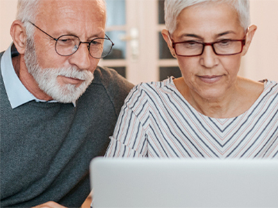 Couple reading laptop together