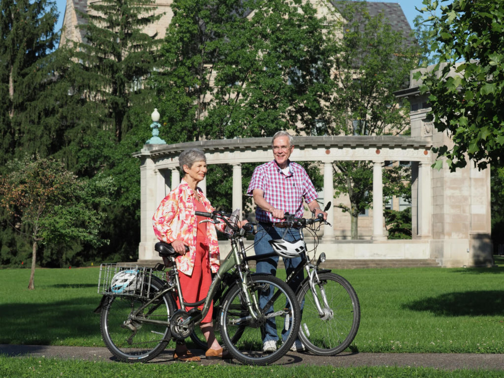 Kendal residents walk bikes on Oberlin College's campus.