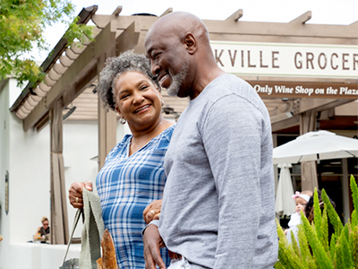 Black couple shopping in village setting