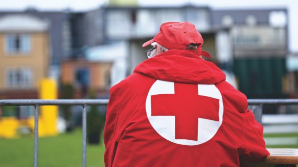 man in red cross jacket