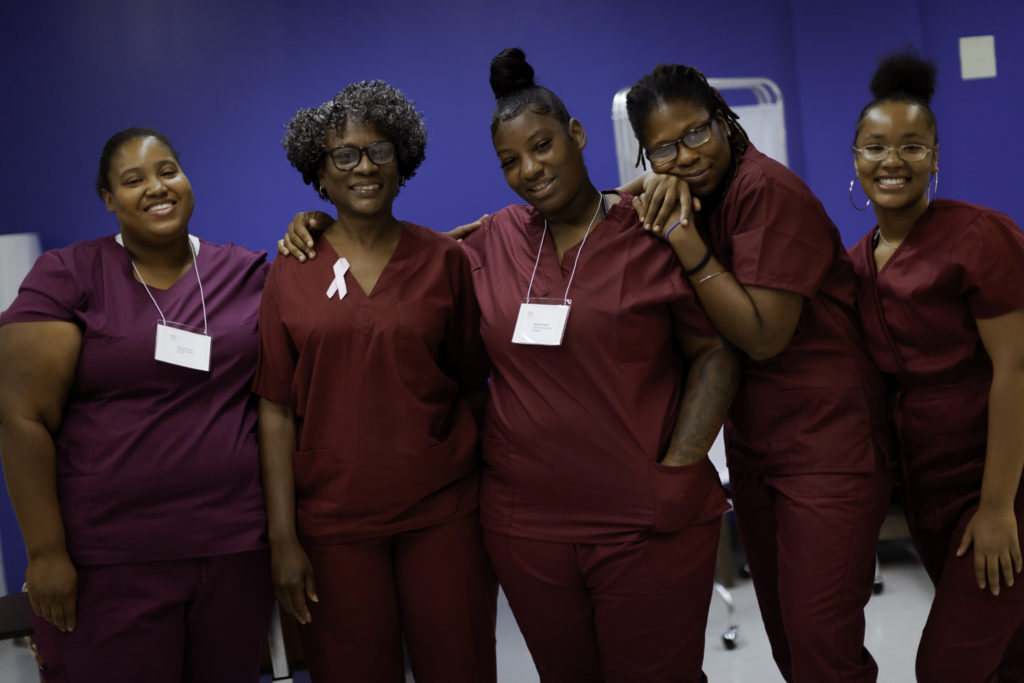 Group of women smiling at CNA training 