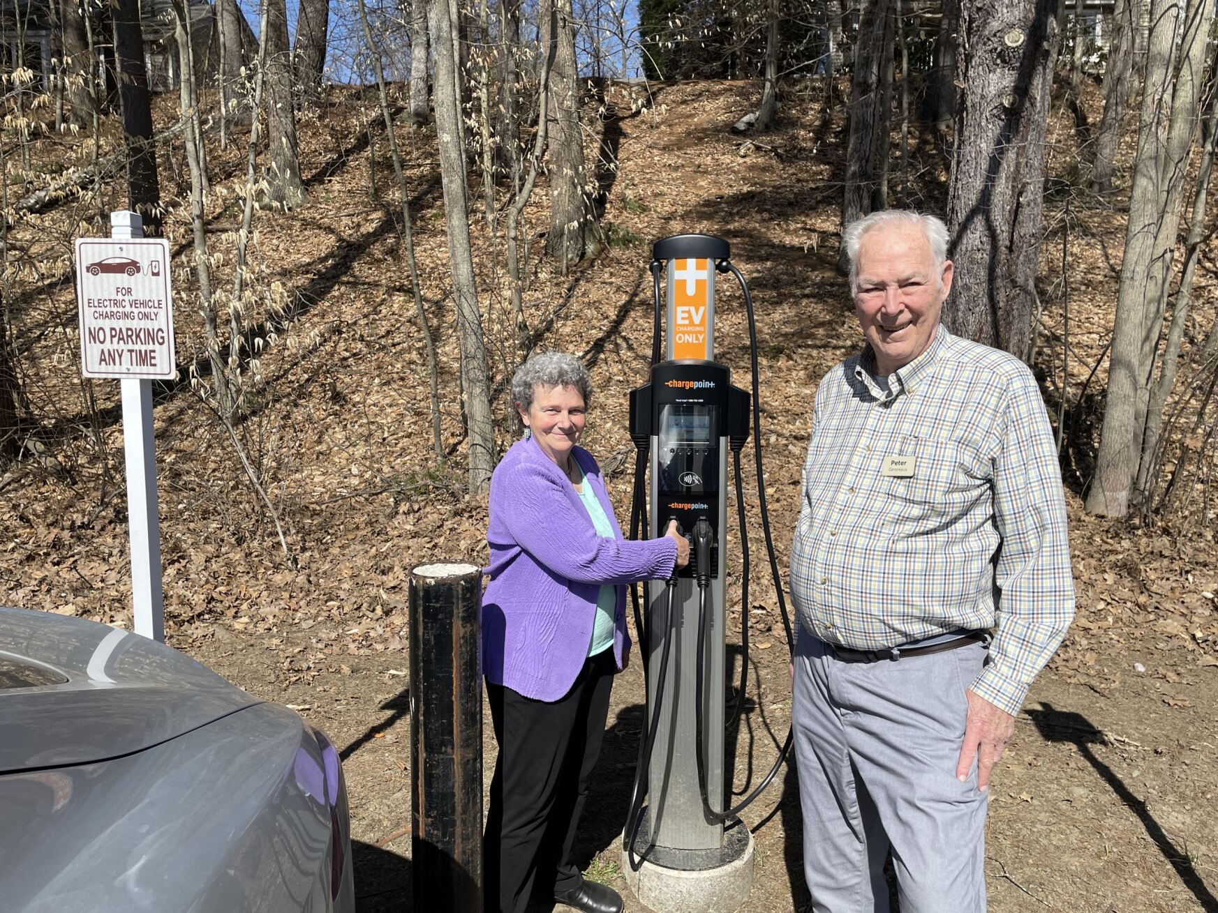 man and woman at Hanover with EV charging station