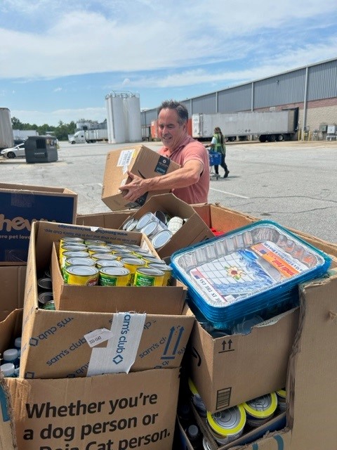 Carlos loads canned goods to be donated