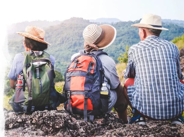 Three hikers looking at mountain