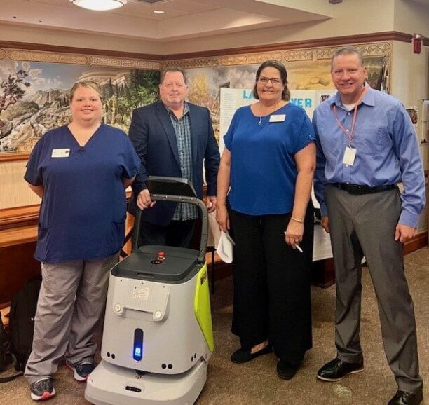 4 people with cleaning robot