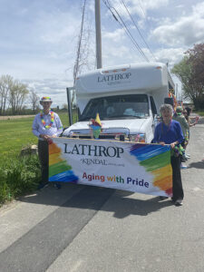 Diverse senior living resident group prepares for pride march