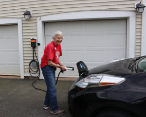 Senior women plugs in EV in sustainability effort in Northampton, MA