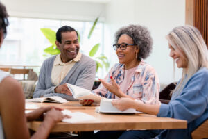 The group member discusses her review of the book with her friends.