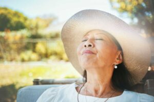 a senior woman relaxing outside in the sun