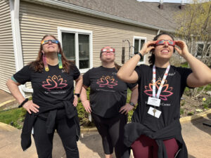 Wellness staff watch the 2024 eclipse